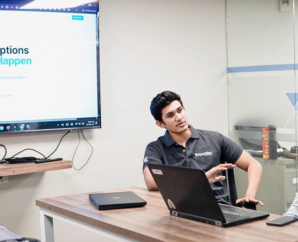 Hashir presenting a software system to colleagues around a table